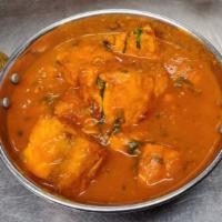 Salmon Curry · Gluten free. Chunks of Salmon cooked with onion and tomatoes gravy.