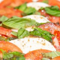 Mozzarella & Tomato Salad · Fresh mozzarella and roma tomatoes, served with balsamic Italian vinaigrette dressing and ga...