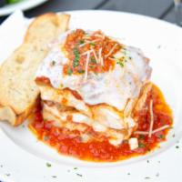 Lasagna · Layers of pasta sheets baked with meat sauce, ricotta and mozzarella cheeses. Served with fr...