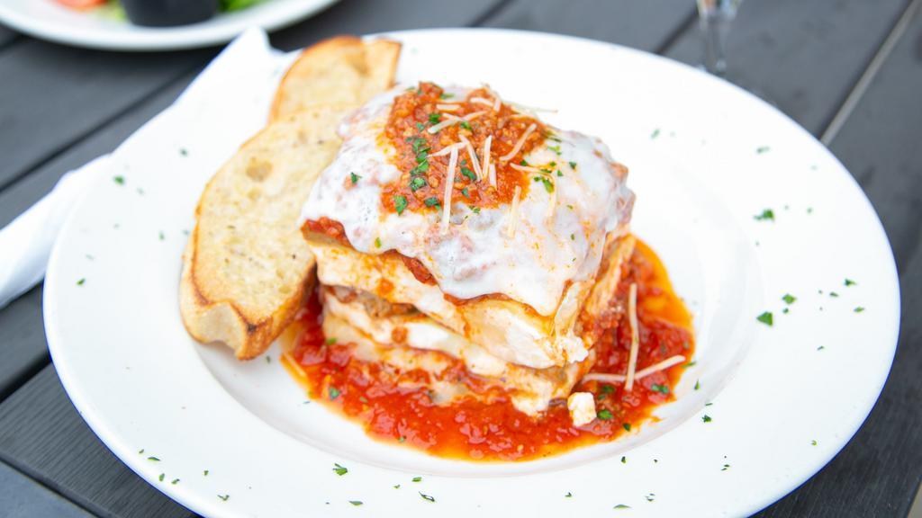 Lasagna · Layers of pasta sheets baked with meat sauce, ricotta and mozzarella cheeses. Served with fresh bread.