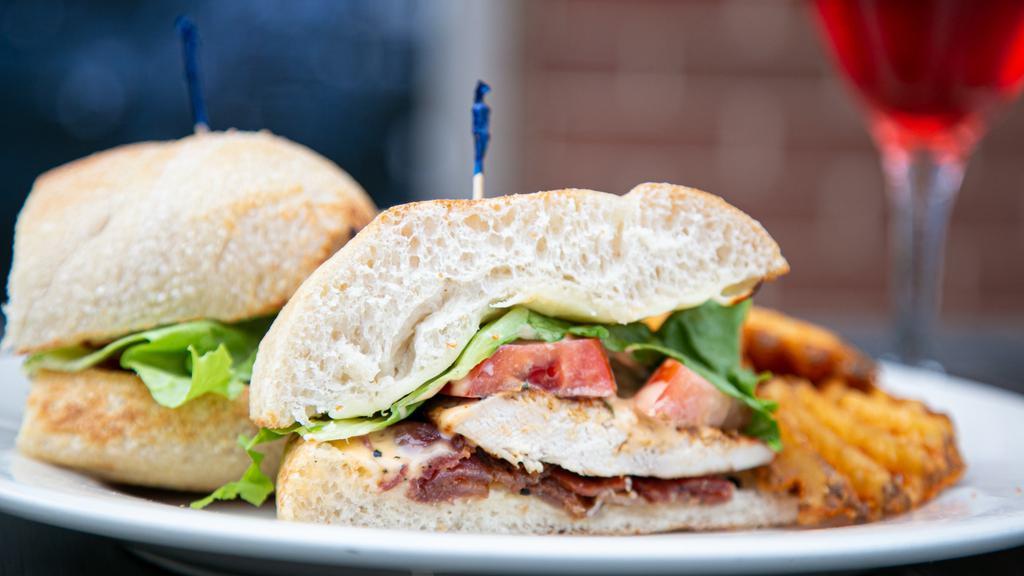 Grilled Chicken Chipotle Sandwich · Grilled chicken, crispy bacon, melted white American cheese, lettuce, tomatoe, all topped with a chipotle dressing and served in homemade bread