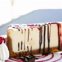 Ny Cheesecake · New York style cheesecake served with raspberry & chocolate sauce.