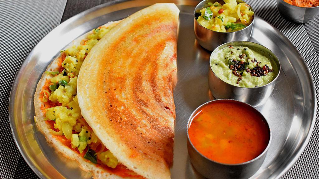 Masala Dosa · Crepe made with Rice. Stuffed with Potato Filing and  Served with Chutney and Sambar (Lentil Soup)