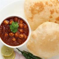 Chole Bathura · Fried Puffy White flour Bread served with Chickpeas Curry.