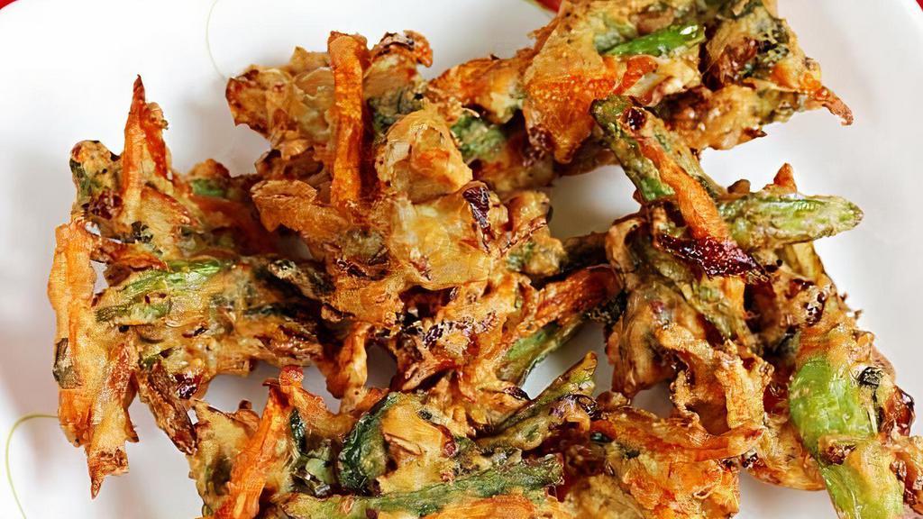 Veg Pakora · Vegetarian. A Delicious Indian Crisp fried Snack made with Gram Flour, Spices and vegetables.