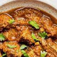 Andhra Goat Curry · It is a Home Style Bone-In Goat Curry cooked in Freshly grounded Masalas.