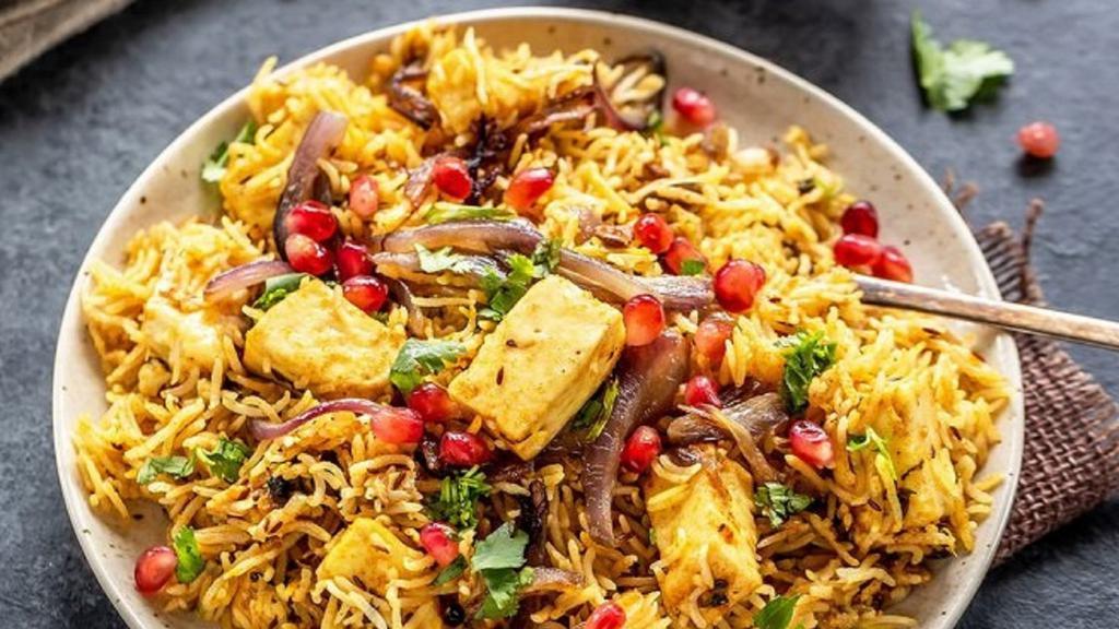 Paneer Biriyani · Flavored rice cooked with Cottage Cheese cubes, Basmati rice and our secret spices.