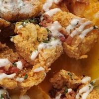 Chicken, Bacon, Ranch · Crispy chicken bites, shredded cheese, bacon topped with ranch.