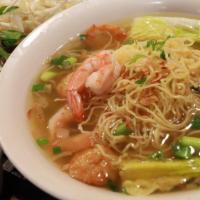 Mì Đồ Biển · Pork broth soup with egg noodles served with shrimp, squid and fish ball. Garnished with let...