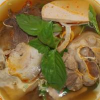 Bún Bò Huế · Spicy beef soup with thick vermicelli noodles, beef shank, slices of vietnamese pork bologna...