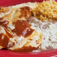 Crazy Pollo · Two grilled chicken breasts topped with red sauce and cheese dip. Served with rice, beans, a...