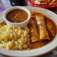 Enchiladas Poblanas (2) · Poblano chile, sauce, com, ground beef and white cheese on top, rice and charros beans.