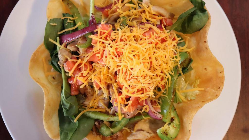 Taco Salad · Flour tortilla crispy, lettuce. tomatoes, cheese, and bell pepper on the grill.
