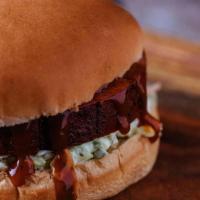 Smoked Bbq Bologna · Seasoned BBQ bologna smoked slow and then grilled to order.  Served on a bun with Tops origi...