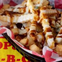 Bar-B-Q Cheese Fries · A basket of Tops crinkle cut fries drizzled with white queso and topped with smoked pork sho...