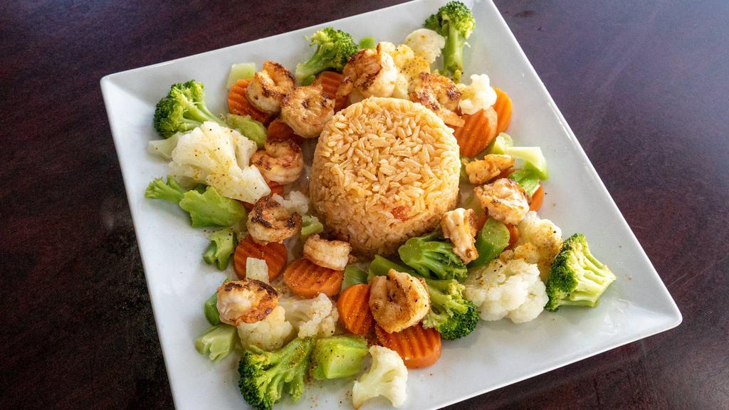 Vegetables Cancun With Shrimp · Grilled shrimp on a bed of steamed cauliflower, carrots and broccoli covered with a cheese sauce, served with rice