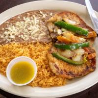 Chuletas Mexicanas · Two seasoned pork chops topped with onions, jalapenos, tomatoes and your choice of ranchero ...