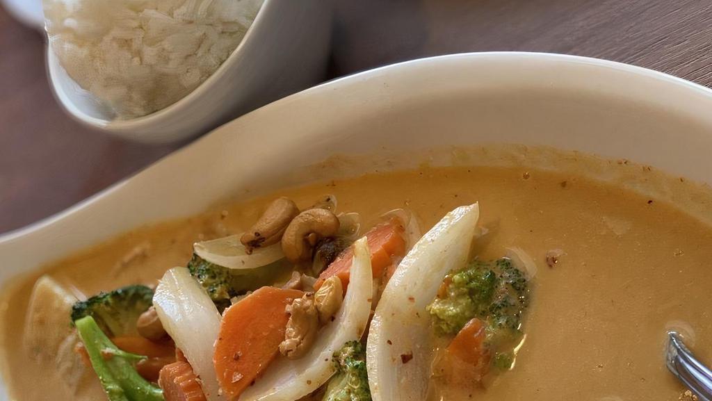 Massaman Curry · Chicken with massaman curry paste in coconut milk, carrot, onions, potatoes, and toppled with cashew nuts. (much flavors of coriander, cardamon, dried mace, ground cloves, lemongrass and galangal).