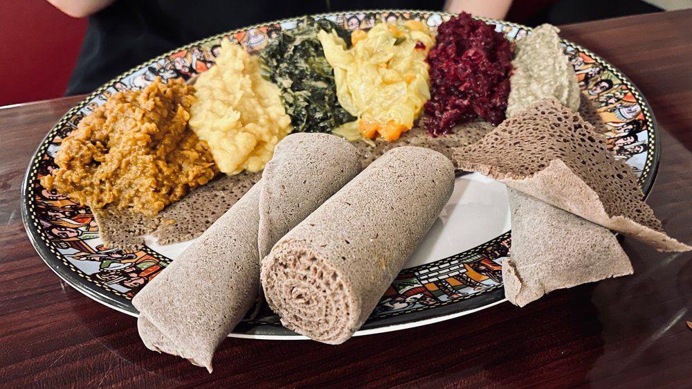 Special Kitfo · Prime ground beef marinated with herbal butter mixed with mitmita (Ethiopian spices), collard greens and house-made Ethiopian cheese. Traditionally raw.