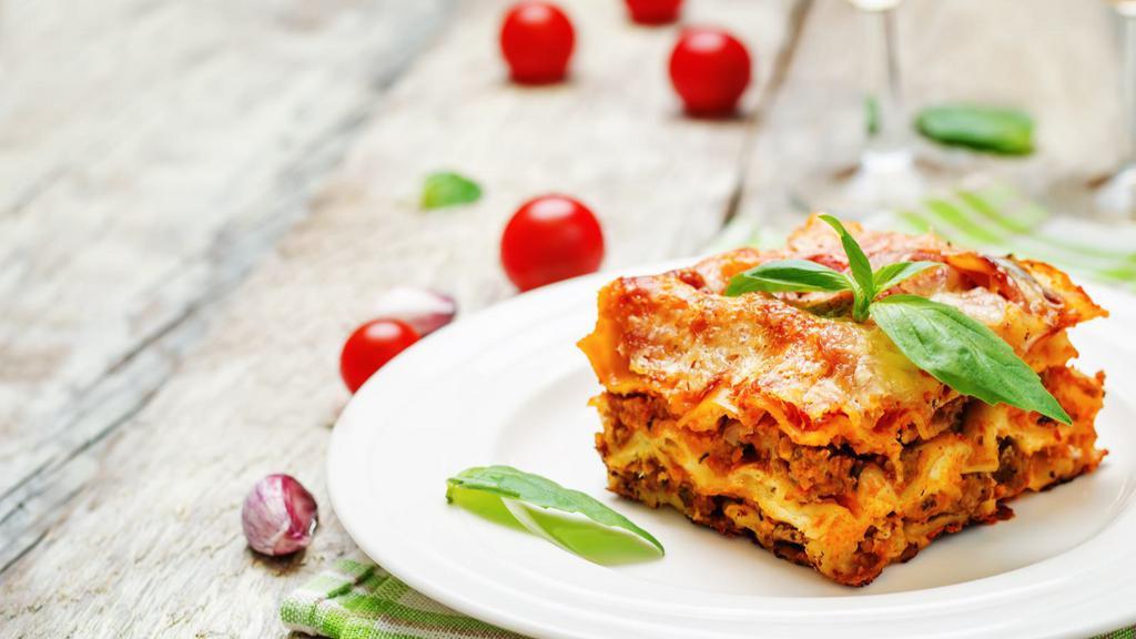 Meat Lasagna · Juicy beef, tomatoes, and mozzarella over layers of beautifully cooked tender pasta, served with freshly baked breadsticks.