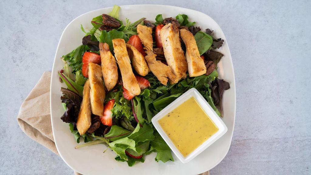 Strawberry Pecan Chicken Salad · Sliced strawberries, candied pecans, and grilled chicken on a bed of spring mix lettuce topped with onion vinaigrette dressing.