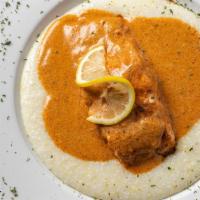 Salmon & Grits · Fresh six oz. pan seared salmon served over our creamy grits and topped with your choice of ...