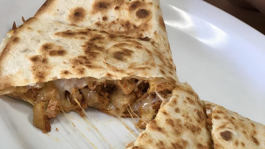 Quesadilla Mexicana · A flour tortilla grilled and stuffed with beans, cheese, and your choice of chopped beef or chicken. Served with lettuce, guacamole, tomatoes, and sour cream.