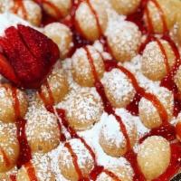 Bubble Waffle · Waffle will come dusted with powdered sugar, drizzled with a sauce of your choice and accomp...