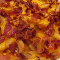 Bacon Cheese Fries* · A heaping amount of golden fries topped with melted cheese and bacon.