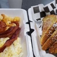 French Toast Combo · Two pieces of French toast served with two eggs, your choice of home fries or grits and your...