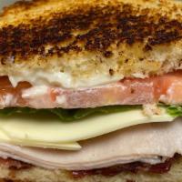 Turkey Club Sandwich · Shaved turkey and cheese topped with lettuce, tomato, bacon and mayo.
