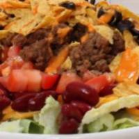 Taco Salad · A flour tortilla deep fried into a bowl, topped with cheese, lettuce and sour cream.