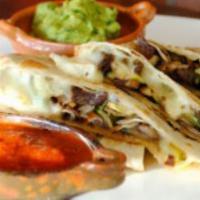 Quesadilla De La Casa · A flour tortilla grilled and stuffed with melted cheese. Served with rice and beans.