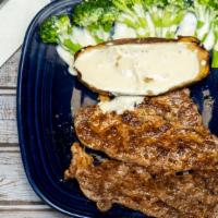 Rib-Eye Dinner · 10 oz. Rib-eye steak served with a baked potato and steamed broccoli. Topped with cheese sau...