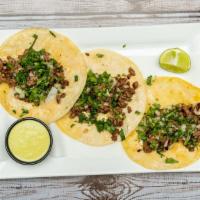 Street Tacos · Three corn tortillas, stuffed with chopped rib-eye. Served with cilantro and onions.