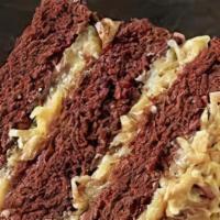 German Chocolate · Our moist German chocolate cake topped with our special Homemade Coconut Pecan icing. Very p...