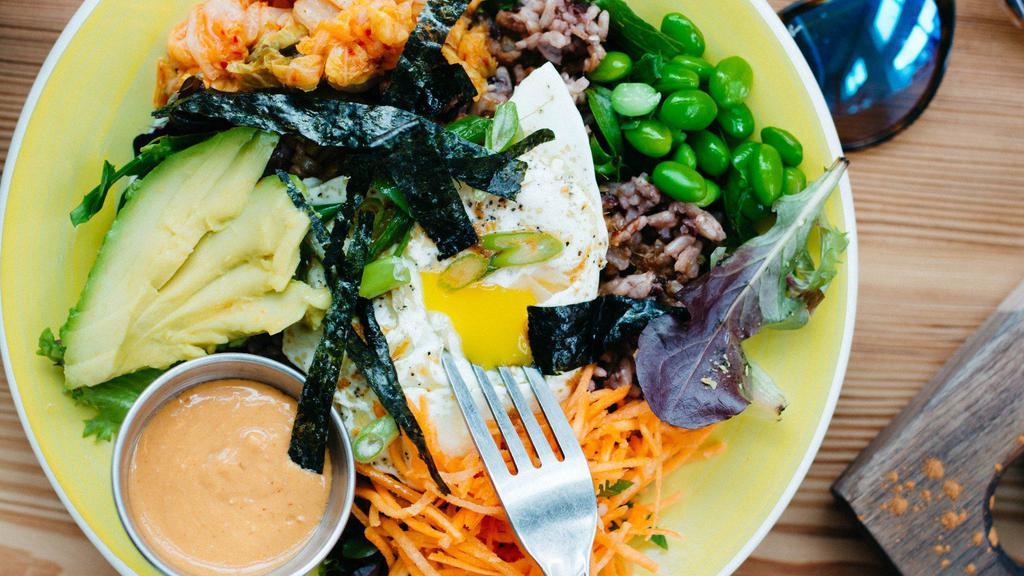 Orbit · Gluten free. Eat fit. Warm wild rice, avocado, pastured egg, kimchi, edamame, carrots, scallions, nori, and sesame ginger dressing.