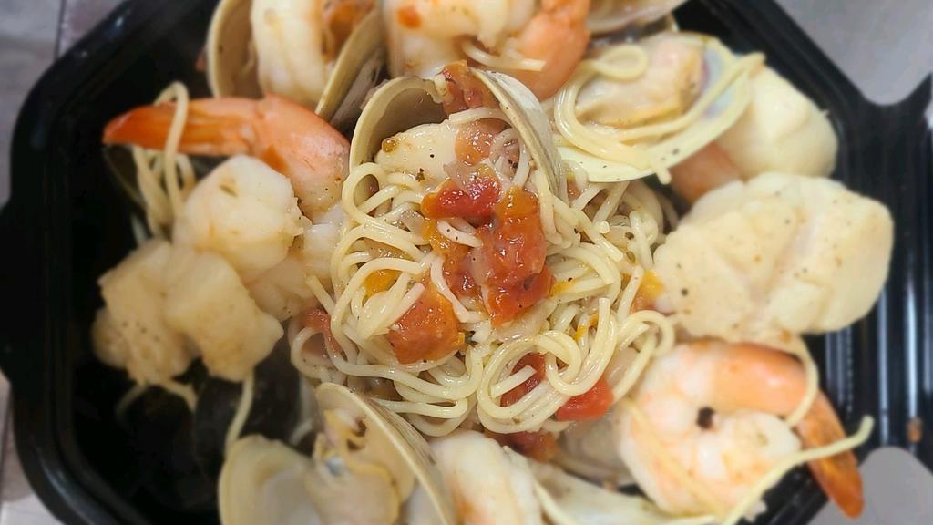 Fruit De Mare · Sautéed Shrimp, Clams, Mussels, Scallops in herb tomato broth with angel hair pasta.