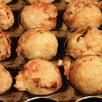 Takoyaki · Six pc batter ball filled with diced octopus served with spicy mayo and eel sauce.