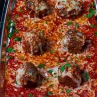Piatto Meatballs · Meatballs topped with melted mozzarella and homemade tomato sauce.