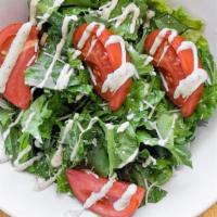 Caesar Salad · Crispy romaine lettuce and tomatoes tossed with our creamy Caesar dressing and parmesan chee...