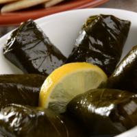 Stuffed Grape Leaves · Cooked grapevine leaves stuffed with rice and spices, served with side of cucumber sauce and...