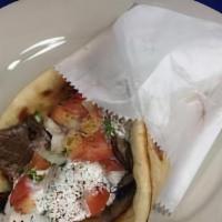 Gyro Sandwich · Beef and lambi cucumber sauce with tomato and onion wrapped in a pita.