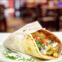 Baba'S Chicken Pita Sandwich · Grilled chicken breast with lettuce, tomato, onion, and ranch dressing wrapped in a pita.