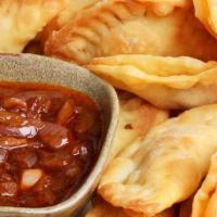 Beef Fataya · Pastry dough stuffed with ground meat cooked in tomato sauce.