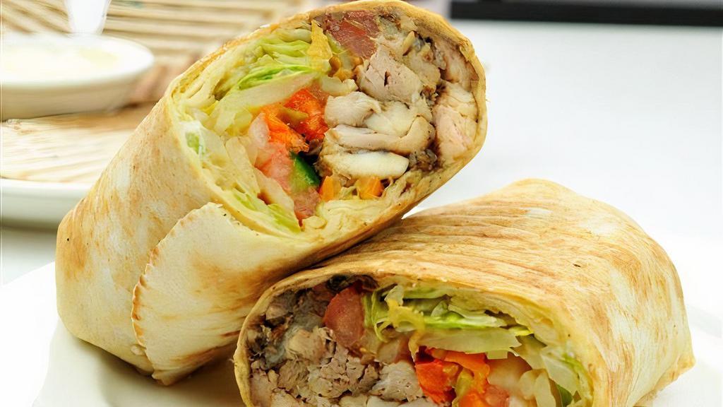Chicken Shawarma · Marinated chicken, onions, parsley, tomatoes, french fries & yogurt dressing wrapped in pita bread
