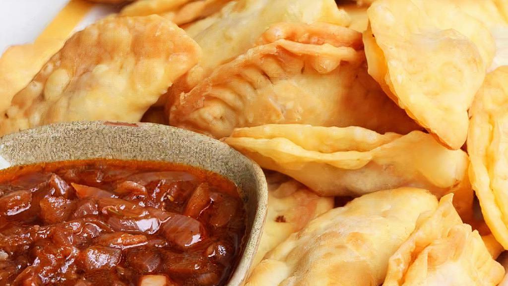 Fish Fataya · Pastry dough stuffed with ground fish cooked in tomato sauce.
