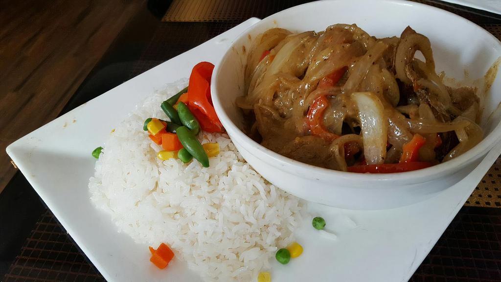 Fish Yassa · Grilled fish marinated in lemon juice & sauteed onions served over white rice