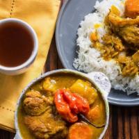 Thue Curry · Stewed Chicken or lamb cooked in a flavorful curry sauce with vegetables.