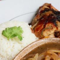 Chicken Yassa · Grilled chicken marinated in lemon juice & sauteed onions served over white rice